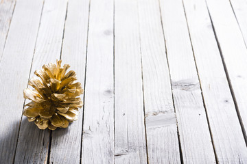 golden pine cone Christmas decoration on old rustic wooden table background