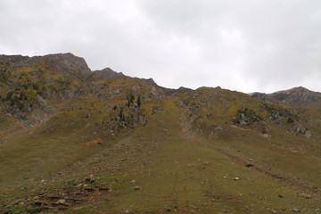 Closeup view of mountains under cloudy sky