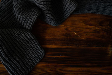 Knitted scarf on wooden background