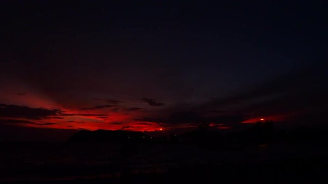 Sunset timelipse on the sea with horizon view and fishing boats
