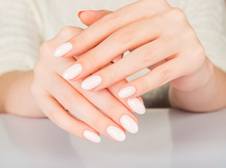 Obraz na płótnie Canvas Beautiful female hand with beige nail design.