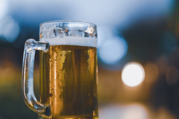 mug of cold craft beer with blurred bokeh background