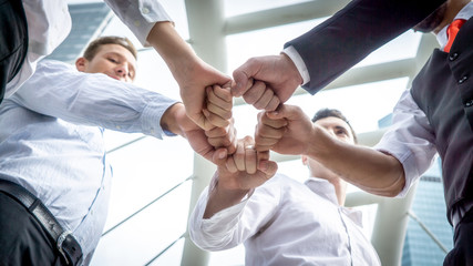 Closeup on hands. Colleague putting their hands on top of each other symbolizing unity and teamwork while doing activity outdoor. People joining hand together as a business goal achievement.