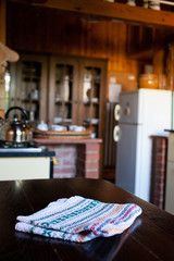 blurred rustic kitchen interior - focus on napkin and desk space