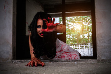 Horror Scene with woman cover the red blood on the body.