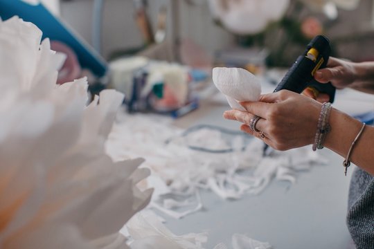 Crop hands creating beautiful paper flower