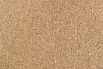Texture of wet sand on sea beach. Close up.