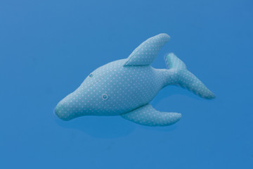 Obraz na płótnie Canvas Dolphin toy floating