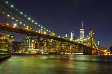 Fototapeta na wymiar Brooklyn Bridge at night with water reflection, New York City Skyline, NY, USA