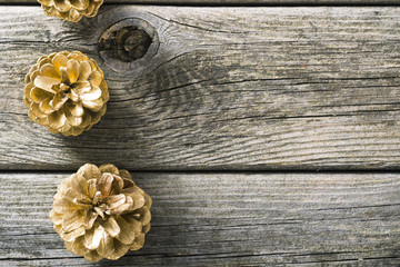 golden pine cones Christmas decoration on old wood table background