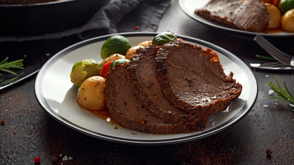 Sliced Roast beef with honey glazed vegetables, served on plate. festive dinner