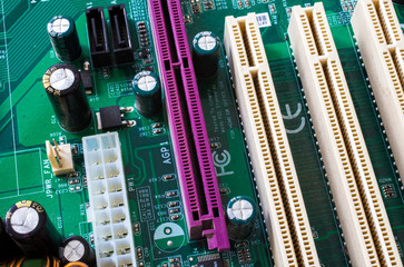 Computer motherboard. Tracks on the printed circuit board. Electronic components. Resistor,...
