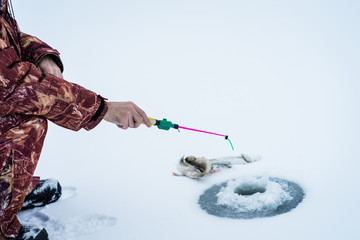 Close-up of man ice fishing on the river\lake