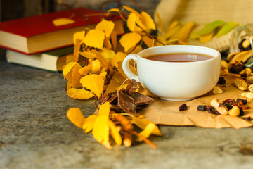 Tea - a cup of tea is brewed tea bag. cup on the table and yellow leaves. top view.