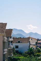 Typical roofs of Tivat on a sunny summer day. Houses surrounded by mountains