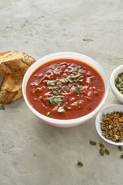 Vegan Tomato Bisque with olive oil, fresh herbs, and pumpkin see