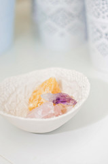 Healing crystals and gemstones on a white table: Amethyst Point, Calcite and rose quartz are bringing positive energy to support inner strength