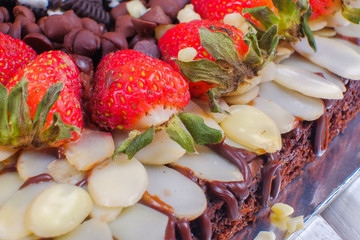 Delicious homemade brownie cake with strawberries. Selective focus