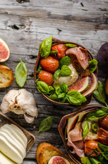 Obraz na płótnie Canvas Homemade fresh figs salad with herbs and roasted garlic toast