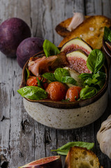 Homemade fresh figs salad with herbs and roasted garlic toast
