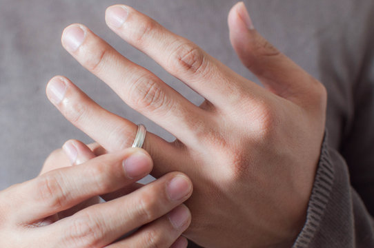 Close up of hands of a man wearing a ring 