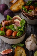 Homemade fresh figs salad with herbs and roasted garlic toast