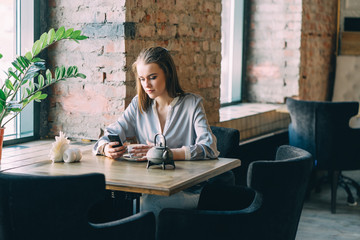 Indoor shot of Pretty Young Woman Sitting in a Cafe