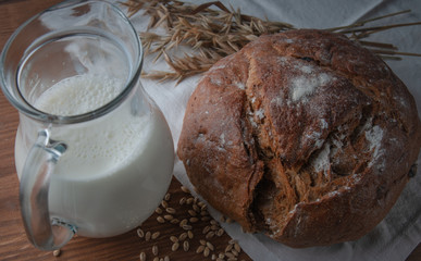 still life on the subject of bread, grain, milk.