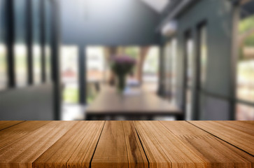 Selected focus empty brown wooden table and Coffee shop or restaurent blur background with bokeh image. for your photomontage or product display.