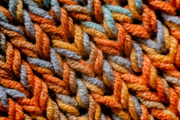 Woman Knitting a scarf. Hands holding threads. Colorfull Knitting