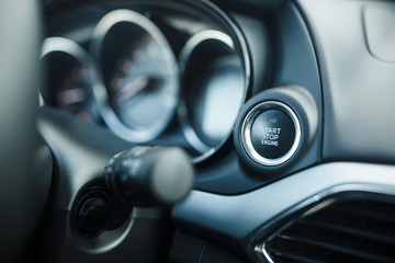 Close up start stop engine modern new car button
