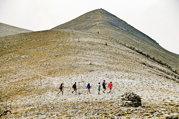 Greece, Olympus mt, climbers walking under the Skolio summit (2.912 m.), the second highest peak of Olympus mt, going towards Christakis refuge, part of the way of the E4 European long distance path.
