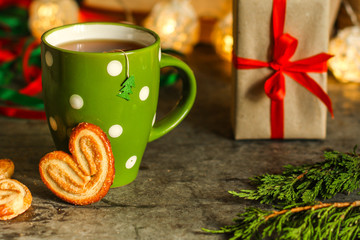 tea - a cup of tea and gifts for the new year. Brewed tea bag. a cup on the table and a festive atmosphere. top view.