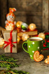 tea - a cup of tea and gifts for the new year. Brewed tea bag. a cup on the table and a festive atmosphere. top view.