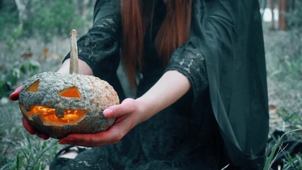 Woman ghost horror her have pumpkin on hand in forest, halloween day concept
