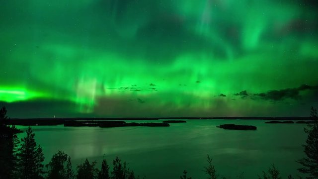 Timelapse of aurora borealis, a magnetic solar phenomenon, above lake Hoytianen, on a cold autumn night, in Huhmari, North Karelia, Finland
