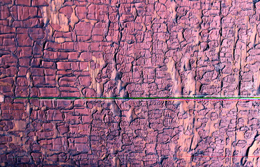Old wooden background with remains of pieces of scraps of old paint on wood. Texture of an old tree, board with paint, vintage background peeling paint. old blue board with cracked paint
