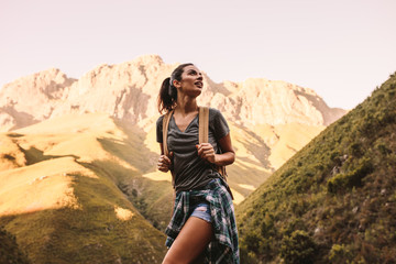 Woman hiking in mountains and looking at the scenic view