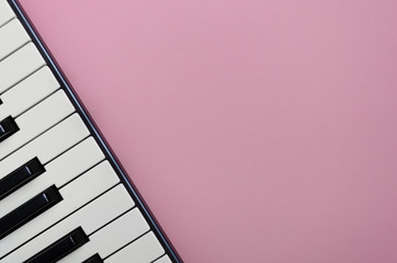 Pink background with a piano  in the left corner