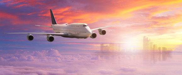 Fototapeta na wymiar Big white airplane is flying over the clouds with colorful sky at sunset for Business trip with Commercial plane , Transportation, import-export and logistics, Travel concept
