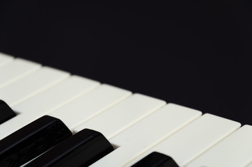 Piano and keys on a black background