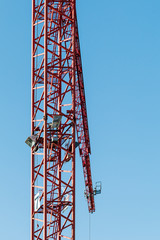 Fototapeta na wymiar Red construction crane in front of blue sky
