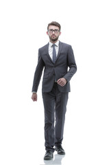 confident businessman goes forward. photo in full growth.