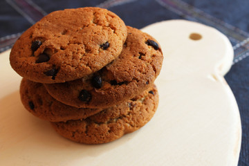 oatmeal cookies with chocolate chips on a wooden stand