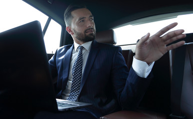 Fototapeta na wymiar Confident businessman talking in car