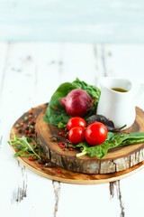 Cherry, tarragon, chili pepper, olive oil, basil, spices Ingredients for cooking pasta. Food background on a white table