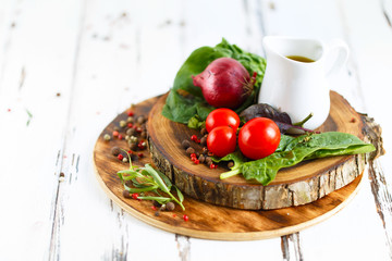 Cherry, tarragon, chili pepper, olive oil, basil, spices Ingredients for cooking pasta. Food background on a white table