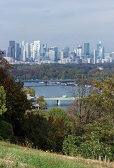 Obraz premium La Defense towers and Seine river bank in Paris suburb
