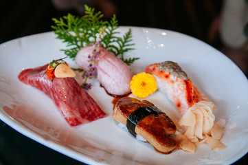 Premium mix sushi on white plate, Foie Gras sushi, Otoro sushi, Wagyu sushi, salmon sushi