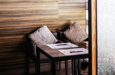 Fototapeta na wymiar Modern Japanese interior wooden dinner table and wall with natural light